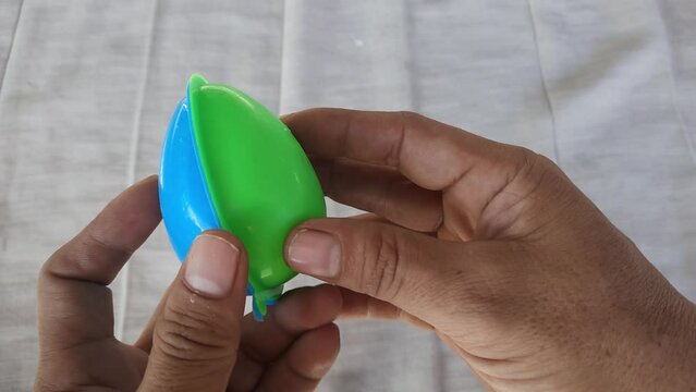 A plastic toy egg is held in a person's hand
