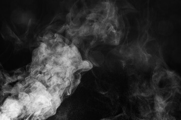 Blur white water vapour on isolated black background. Abstract of steam with copy space.  Smoke on black background. Steam flow.