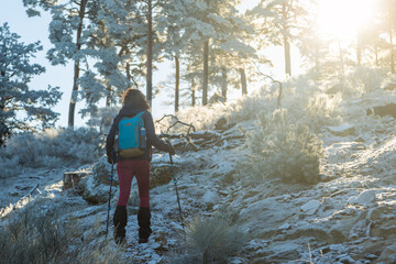 Woman hiking in the snow. In the mountains in the Sierra de Guadarrama National Park. Spain