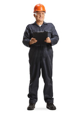 Male factory worker in an overall uniform and orange helmet holding a clipboard
