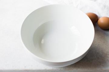 ceramic bowl on a marble table, white ceramic mixing bowl