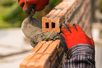 Hand worker masonry brickwork trowel construction site wall concrete background - 720051015