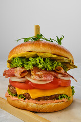 Beef burger with bacon, cheese and vegetables