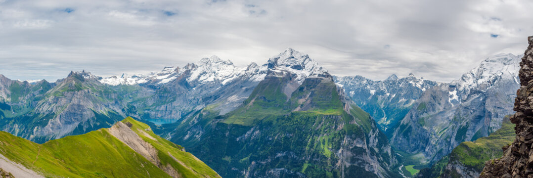 Beautiful summer mountain panorama of the Bernese Alps and Lake Oeschinensee, Switzerland, Europe.