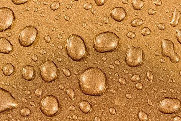 Fototapeta na wymiar Abstract background with water drops on brass textured surface