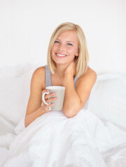 Woman, portrait and coffee in bedroom for morning relax or home beverage for comfort, peace or happy. Female person, face and smile or drinking mug on duvet or warm caffeine for vacation, rest or tea