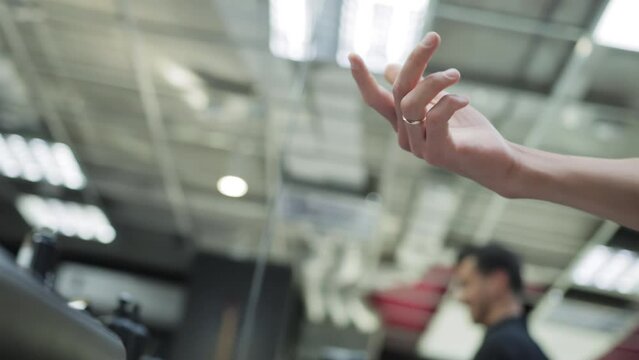 A man's hand rotates and flips a hair clipper in a hairdressing salon. The concept of modern stylish haircuts in a barbershop, close-up. Slow motion