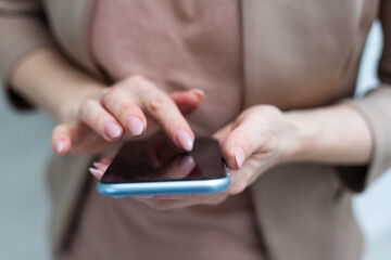 A businesswoman is holding mobile phone - on white background