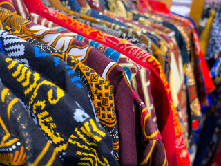 Rows of Batik clothes in a shop, hang on racks for sale. Batik is a type of traditional cloth in Indonesia, Batik has a variety of patterns and colors