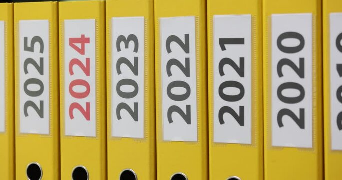 Many yellow folders for office documents for 2022 2023 2024