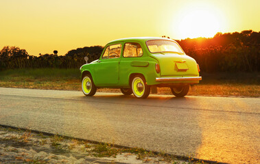 retro car near a private house on the road. Sunset. Bright car. Round headlights. High quality photo
