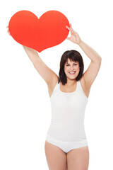 Portrait, heart and happy plus size woman in studio isolated on a white background. Love, sign or...