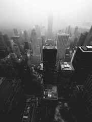 Monochrome Metropolis: City in Haze. Black and white aerial view of a hazy city skyline.