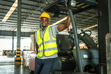 Happy African American male engineer driving and operating on a forklift truck in the industry...