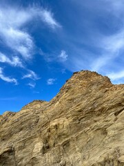 sandstone rock in the blue sky background, ocean rocky coast