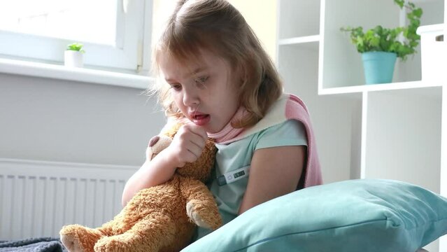 Child cough, little girl sick. Ill kid in bed with a thermometr. Caucasian toddler has a temperature.