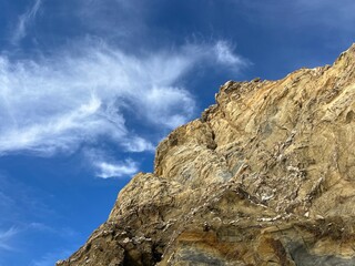 sandstone rock in the blue sky background, ocean rocky coast