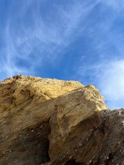 Fototapeta na wymiar sandstone rock in the blue sky background, ocean rocky coast