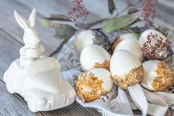 Obraz na płótnie Canvas Easter background with festive eggs and decorative ceramic hare.