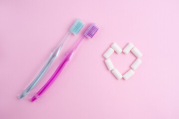Toothbrush and chewing gum lie on a colored background. Time to brush your teeth. Top view, flat...