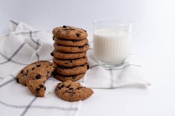 Stack of delicious cookies with chocolate and milk or yogurt on the table. Food and sweet concept. Place for text. Sweet snack
