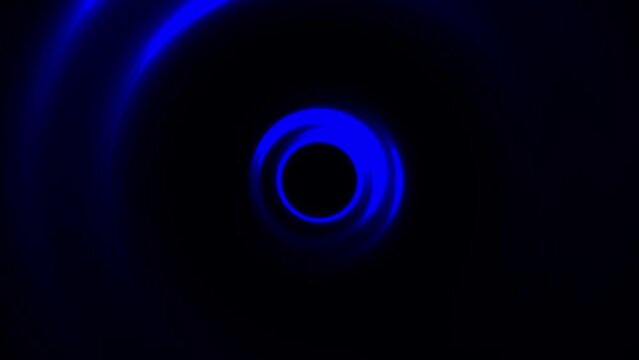 Animation of abstract flashy circle with light beams rotating on black background