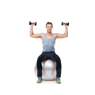 Happy man, ball balance or portrait in dumbbell workout performance, wellness or white background. Strong athlete, training equipment or fitness studio for exercise mockup space or lifting weights © peopleimages.com