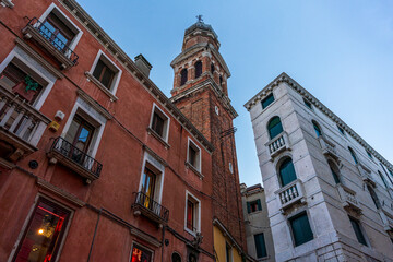 Italian Church Tower with historical old facade in a bottom up view