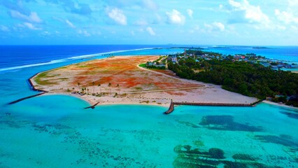 Maldives - Huraa Island - Aerial view with a view over the island, the main island of Male appears...