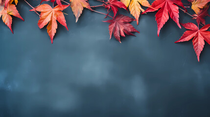 Autumn background with colored red leaves on blue slate background. Top view, copy space