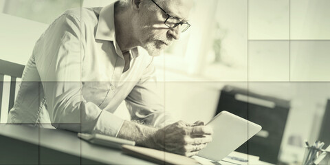 Senior businessman using a digital tablet, geometric pattern