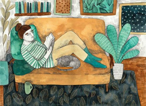 A girl reading a book on a sofa
