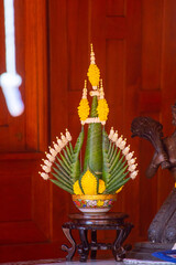 Thai style of rice offering (Pan Bai Sri) decorative with colorful floral and banana leaf folded isolated