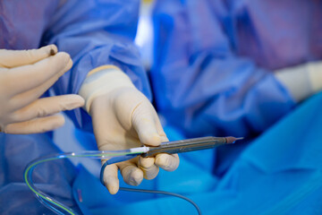 Surgeon holds surgical instrument in his hand