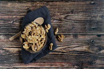 Walnuts in a bowl on a wooden table
