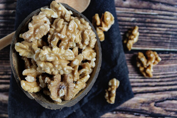 Walnuts in a bowl on a wooden table