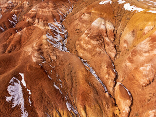 Stunning aerial view of Kyzyl-Chin Mars-like landscapes with vibrant hills in Altai. A display of nature palette.