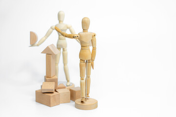 Wooden doll with wooden toy block isolated on white background. business or creative concept