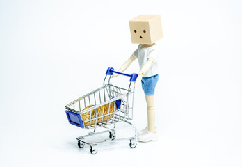 Wooden doll with shopping cart on white background. business or creative concept