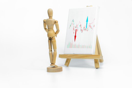 Mannequin drawing a graph charts on easel; isolated on white background; Business or finance concept