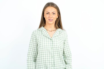 Portrait of dissatisfied Young beautiful woman standing over white studio background smirks face,...