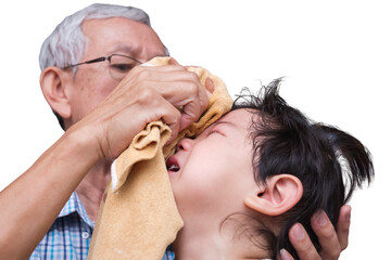 Elderly Man Wiping Tears from Child's Face, Senior man gently wipes away tears from young Asian...