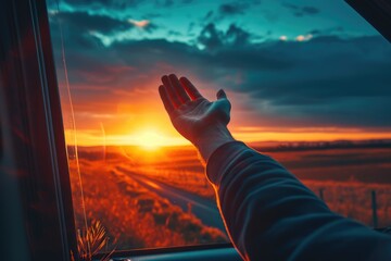 man in car window waving his hand and catching the wind at sunset, travel concept