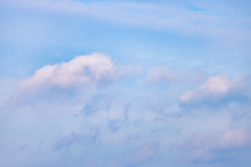 A beautiful sky tinted by the sun leaving vibrant shades of gold, pink, blue and multicolored. Clouds in the twilight evening and morning sky. Cloudy sky background in the evening and during the day.