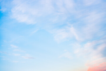 A beautiful sky tinted by the sun leaving vibrant shades of gold, pink, blue and multicolored. Clouds in the twilight evening and morning sky. Cloudy sky background in the evening and during the day.