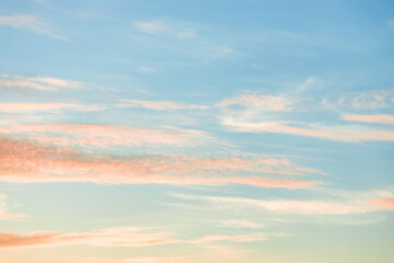 A beautiful sky tinted by the sun leaving vibrant shades of gold, pink, blue and multicolored. Clouds in the twilight evening and morning sky. Cloudy sky background in the evening and during the day.