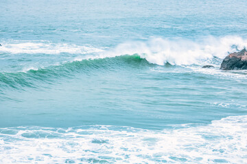 Wave splashing close-up. Crystal clear sea water, in the ocean in San Francisco Bay, blue water, pastel colors.