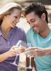 Happy couple, champagne and toast outdoor for celebration of love, holiday and valentines day in park. Man and woman with wine glasses, drinks and cheers on date for success or anniversary in nature