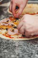 hand of chef baker making pizza at kitchen. The process of making pizza. cooking italian pizza