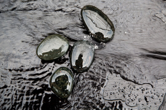 Zen-style black stones on the water surface